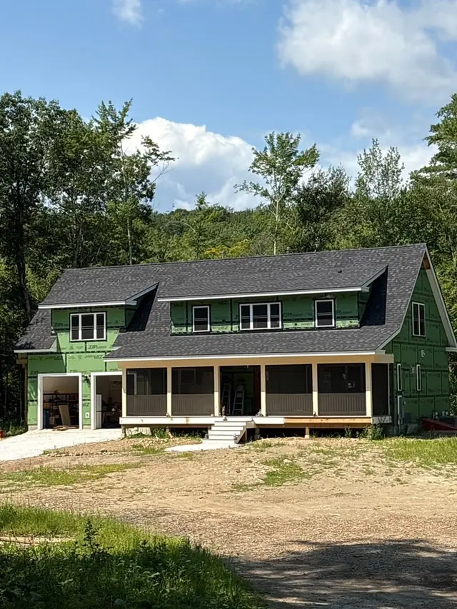 Full exterior of a home with gutters, siding and roof by Teddy Pro Exteriors